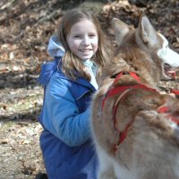 Petting Sobo during a break in the dryland dog sledding action